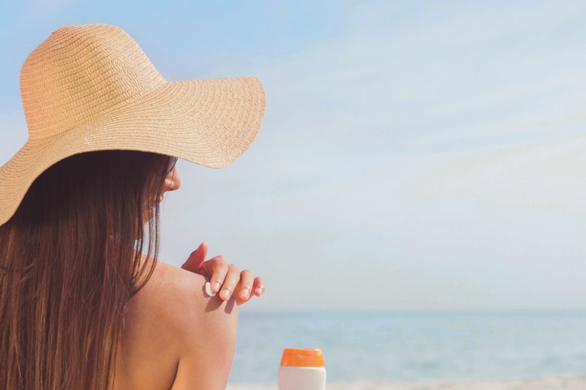 Woman applying sunscreen