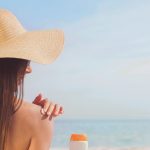 Woman applying sunscreen